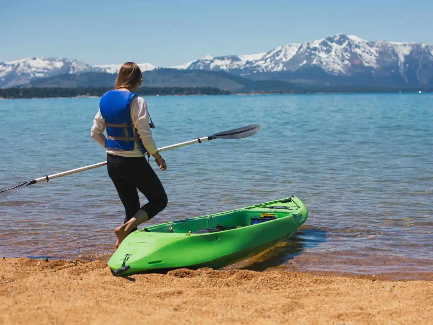 a person in a green boat on a body of water