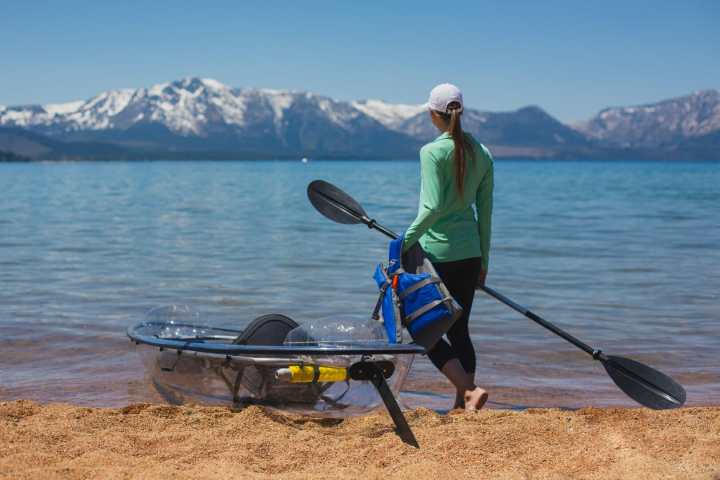 a man standing in front of a body of water