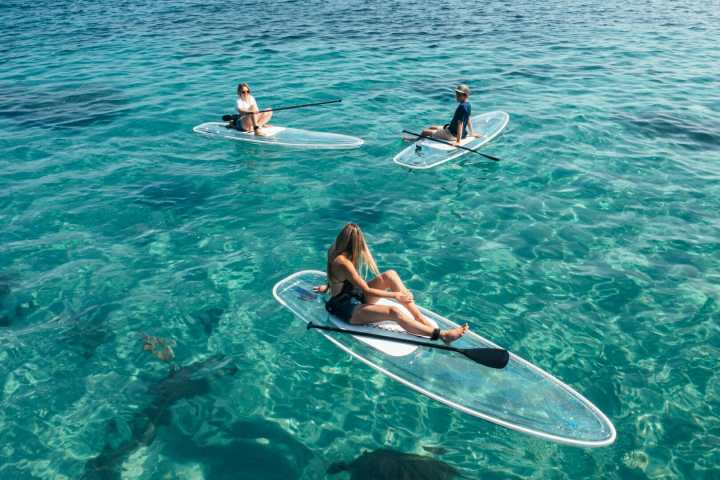a person riding a surf board on a body of water