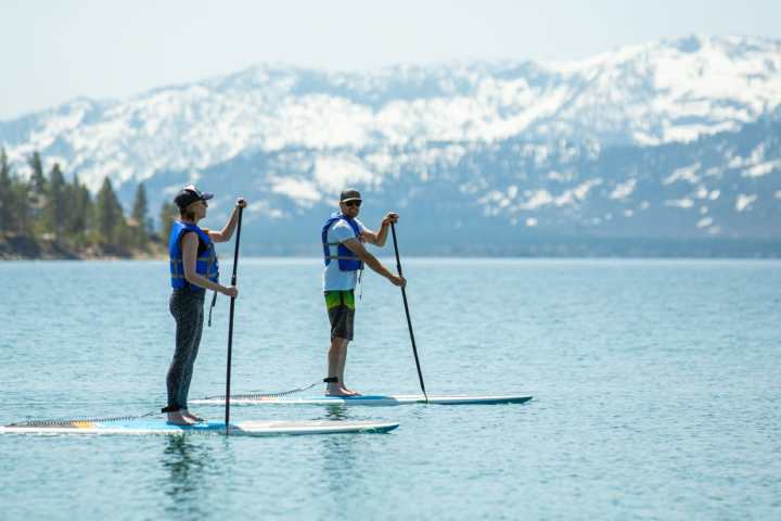a man standing next to a body of water