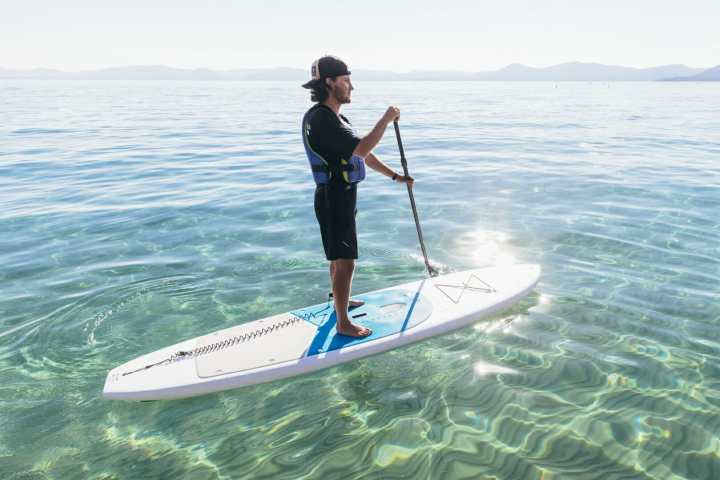a person riding a surf board on a body of water
