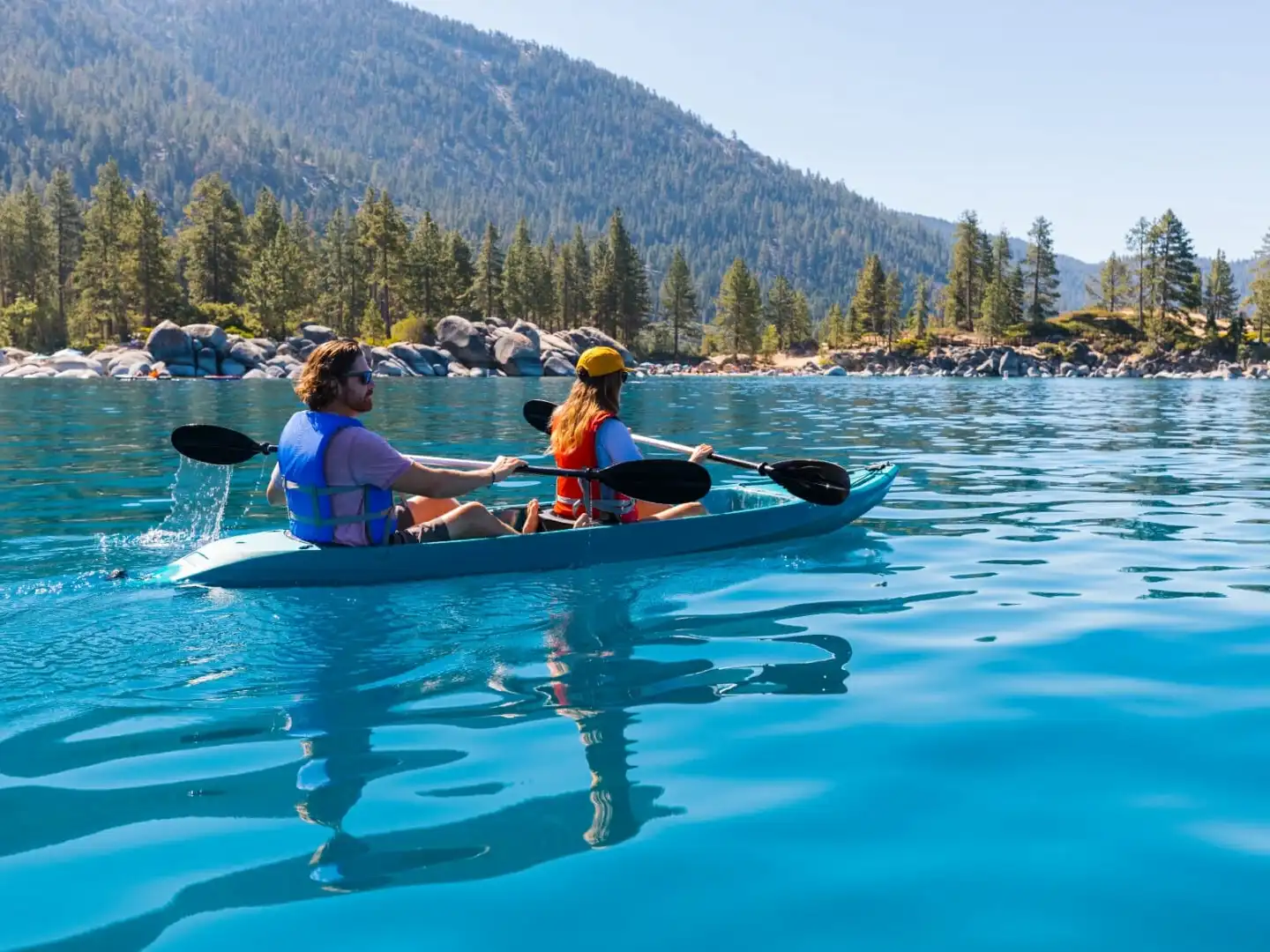 a group of people rowing a boat in the water