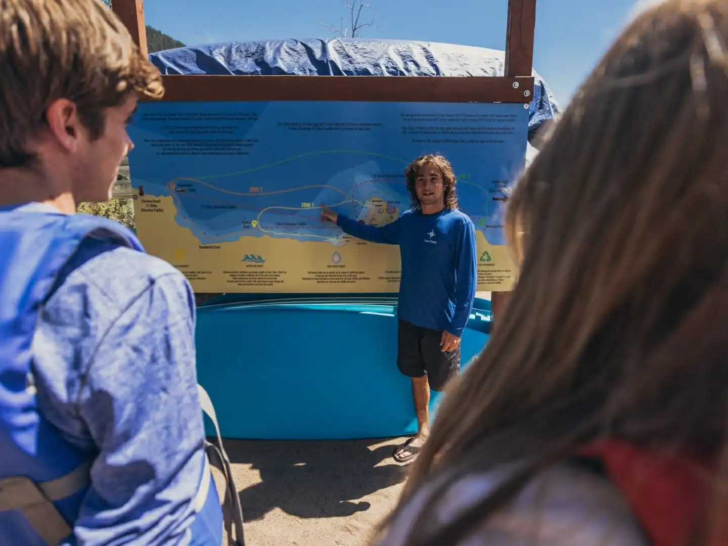 a group of people looking at a computer