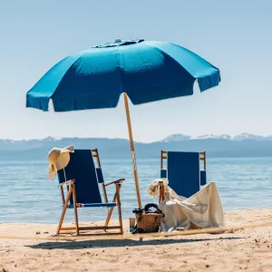 a couple of lawn chairs sitting on top of a beach