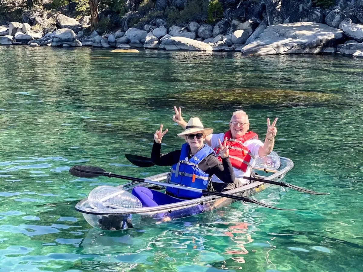 a group of people rowing a boat in the water