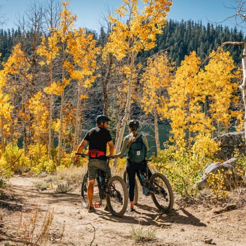 a man riding a bike down a dirt road