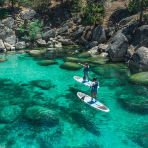 a group of people on a rock in a pool of water